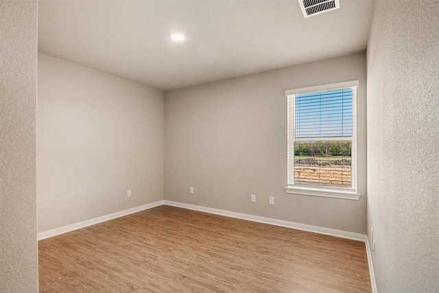 spare room with light wood-type flooring