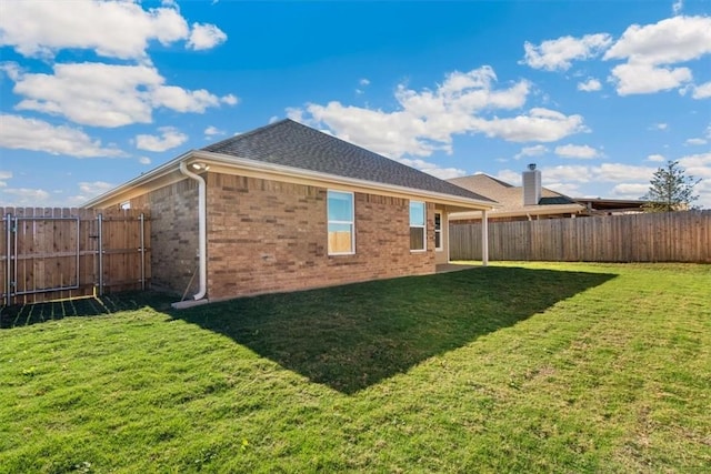 rear view of house with a lawn