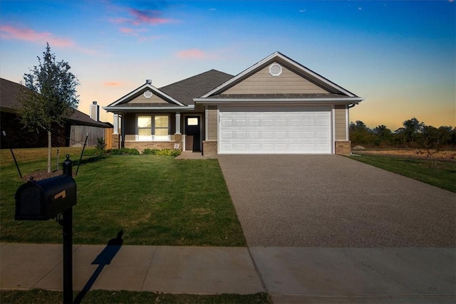 view of front of property featuring a garage and a lawn