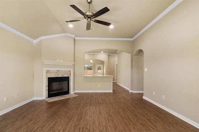 unfurnished living room with dark hardwood / wood-style flooring, vaulted ceiling, ceiling fan, and ornamental molding