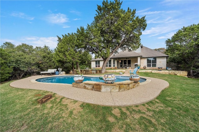 view of swimming pool with a yard and a patio