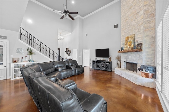 living room featuring a fireplace, a towering ceiling, a wealth of natural light, and crown molding