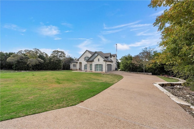 view of front of house with a front lawn and a garage