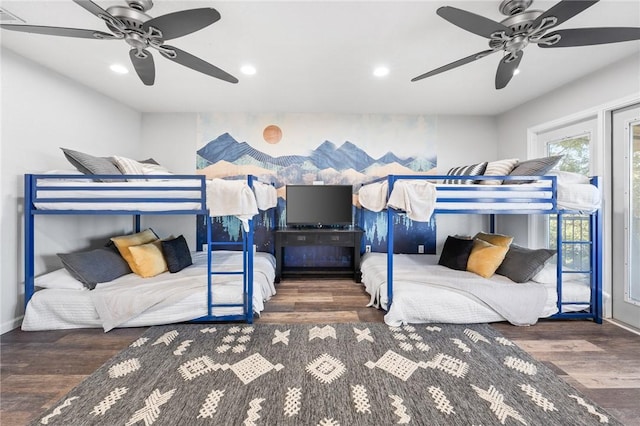 bedroom with ceiling fan and dark wood-type flooring