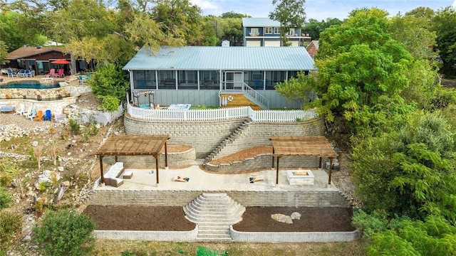 back of house with a sunroom and a patio