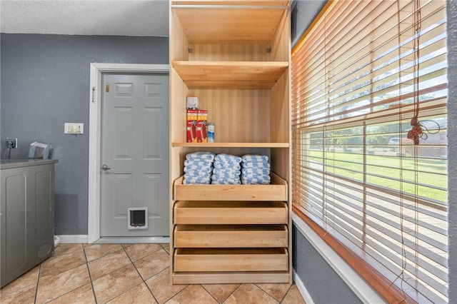 interior space featuring washer / clothes dryer and light tile patterned flooring