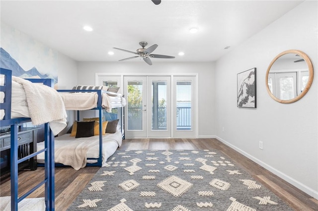 bedroom featuring ceiling fan, dark hardwood / wood-style flooring, access to outside, and french doors