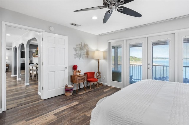 bedroom featuring ceiling fan, dark hardwood / wood-style floors, access to outside, and french doors