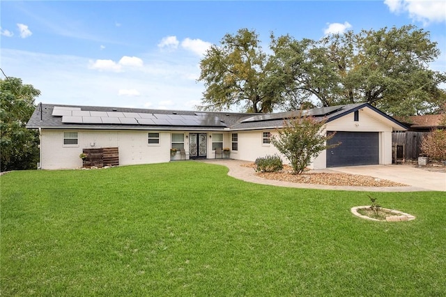 exterior space featuring solar panels, a garage, and a yard