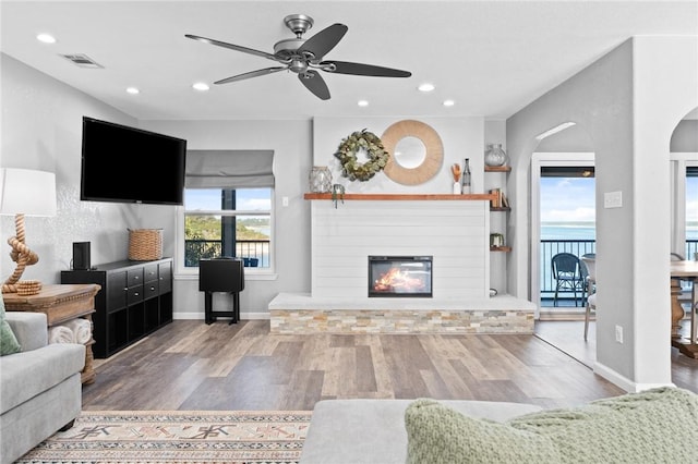 living room with hardwood / wood-style flooring and ceiling fan