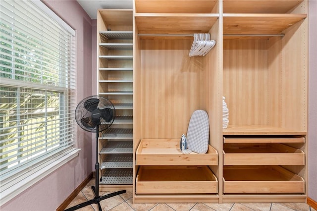 walk in closet with light tile patterned flooring