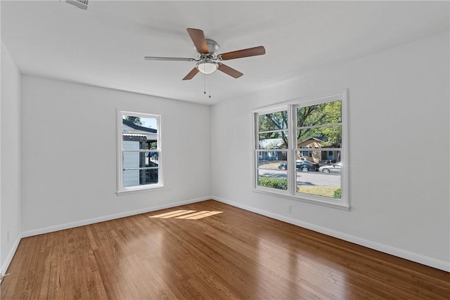 spare room with wood-type flooring and ceiling fan