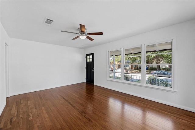 empty room featuring ceiling fan and dark wood-type flooring