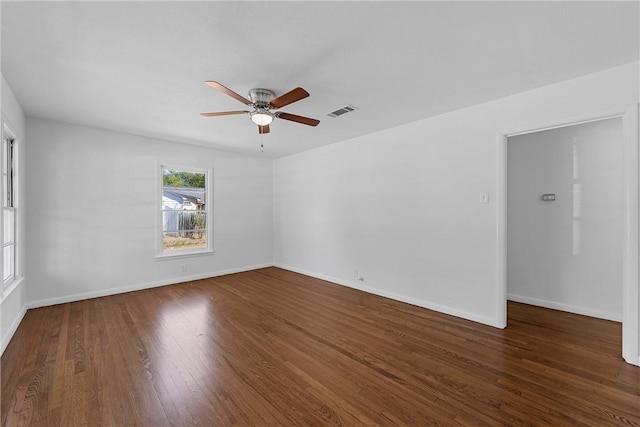 spare room featuring ceiling fan and dark hardwood / wood-style flooring