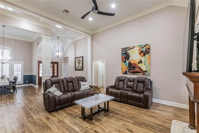 living room with crown molding, high vaulted ceiling, wood-type flooring, and ceiling fan with notable chandelier