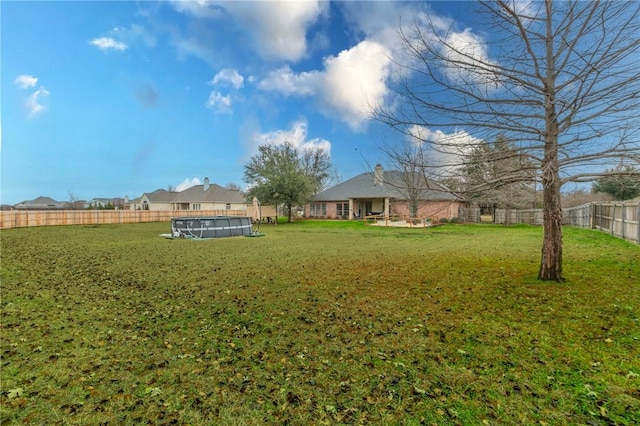 view of yard with a fenced in pool