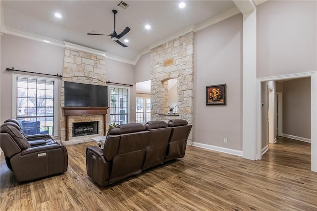 living room featuring ceiling fan, a wealth of natural light, crown molding, and high vaulted ceiling