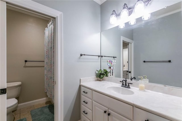 bathroom with tile patterned flooring, vanity, and toilet