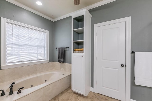 bathroom with tile patterned floors, built in shelves, a bathtub, and a wealth of natural light