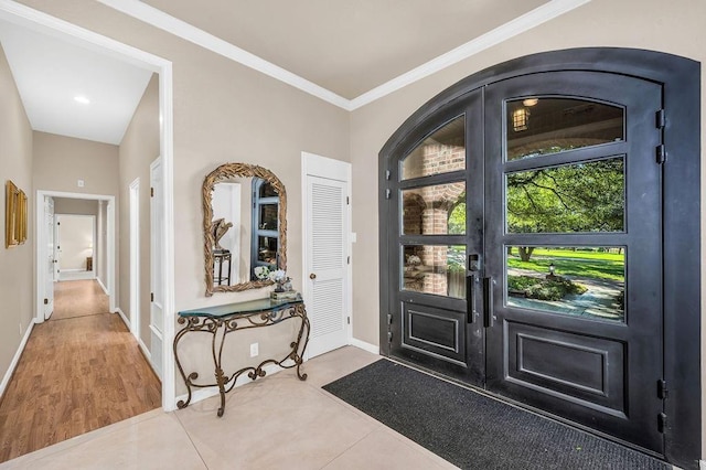 foyer featuring french doors and ornamental molding