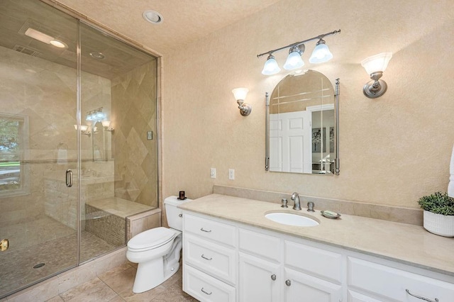 bathroom with vanity, tile patterned floors, a shower with door, and toilet