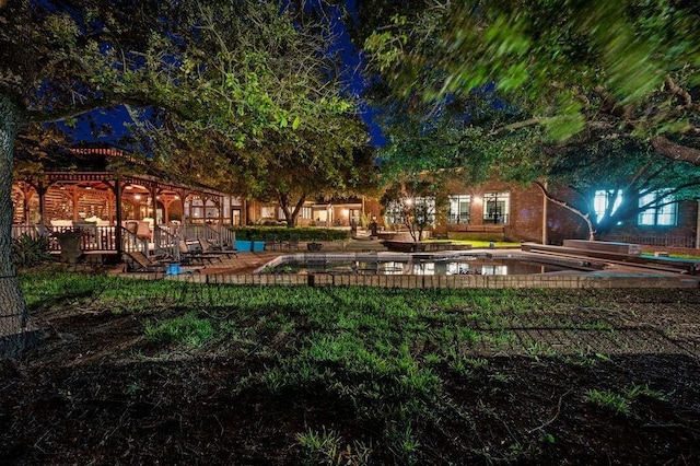 yard at night with a pergola