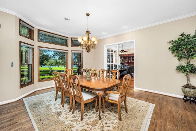 dining space with hardwood / wood-style floors and ornamental molding