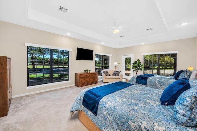 carpeted bedroom with a raised ceiling, ceiling fan, access to outside, and multiple windows