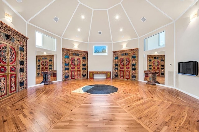 exercise area with high vaulted ceiling and hardwood / wood-style floors