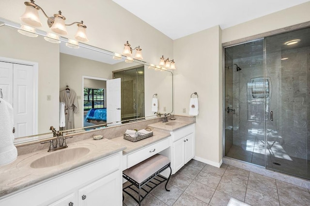 bathroom with vanity, a shower with shower door, and tile patterned flooring