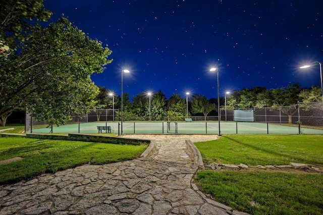 view of sport court featuring a lawn