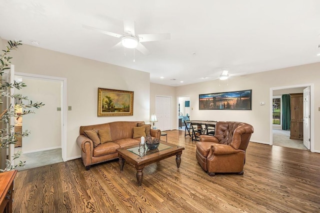 living room with ceiling fan and wood-type flooring