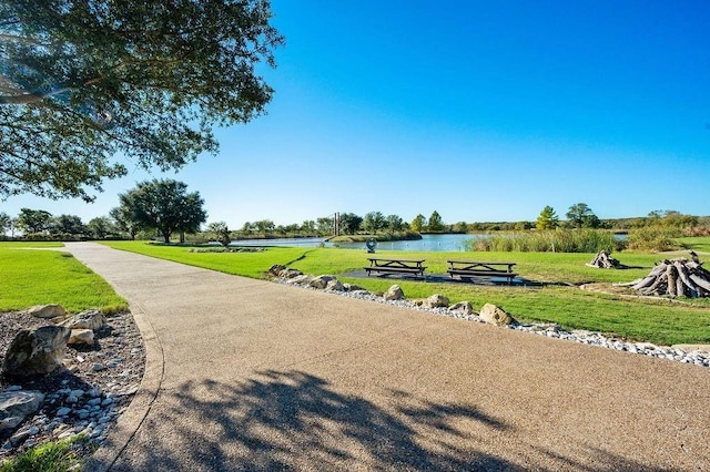 view of home's community featuring a yard and a water view