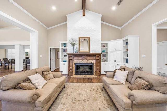 living room featuring ornamental molding, wood-type flooring, lofted ceiling with beams, and a premium fireplace