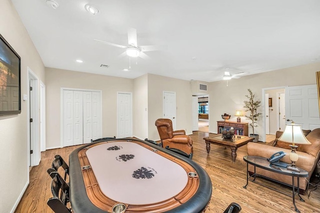 rec room featuring ceiling fan and light hardwood / wood-style floors