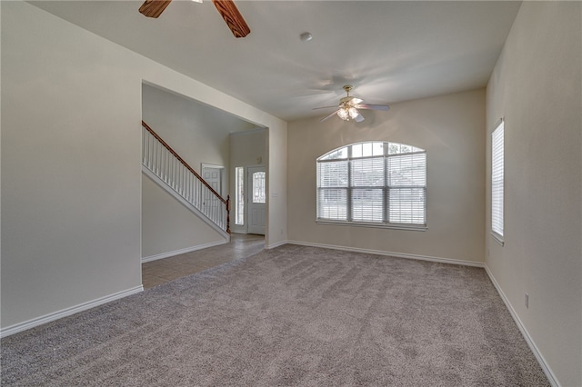 unfurnished living room featuring light carpet and ceiling fan