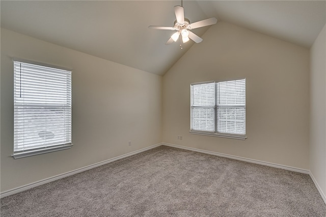 carpeted empty room featuring ceiling fan and vaulted ceiling