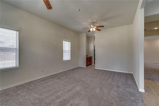 unfurnished room with light carpet and ceiling fan