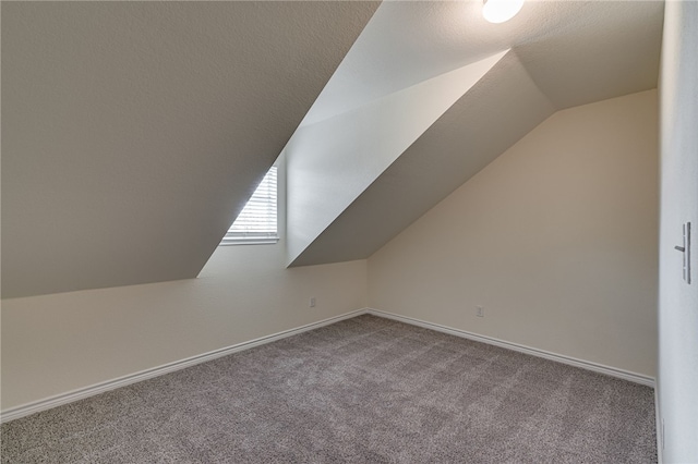 bonus room with carpet flooring, a textured ceiling, and lofted ceiling