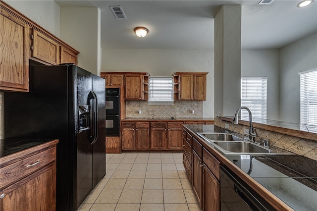 kitchen with black appliances, backsplash, light tile patterned flooring, and sink