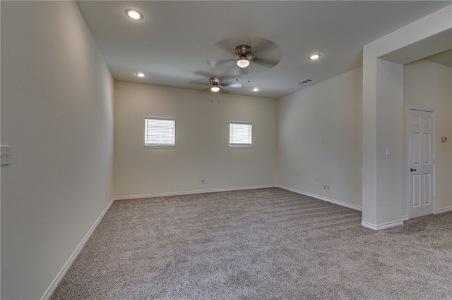 carpeted spare room featuring ceiling fan