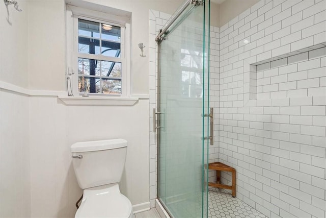 full bath featuring toilet and a shower stall