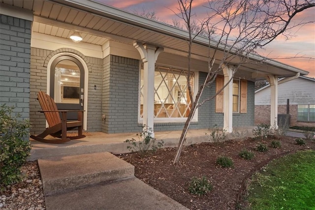 exterior entry at dusk with brick siding