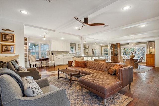 living room with recessed lighting, visible vents, beamed ceiling, and wood finished floors