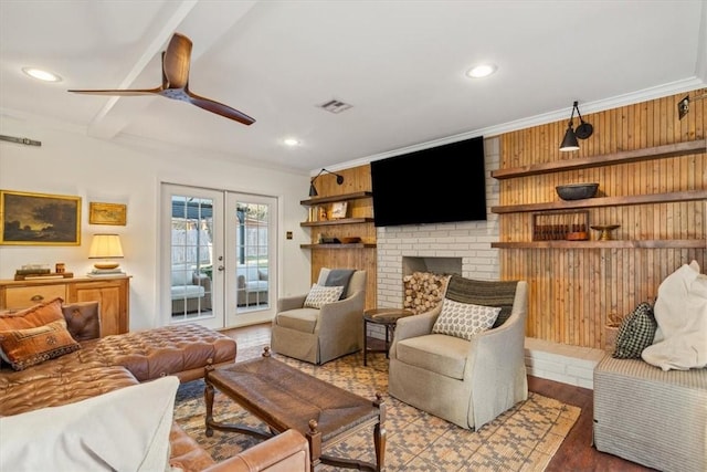 living area with visible vents, wood finished floors, french doors, a fireplace, and recessed lighting