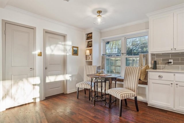 sitting room with ornamental molding, dark wood finished floors, and baseboards