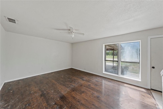 unfurnished room with a textured ceiling, dark hardwood / wood-style flooring, and ceiling fan