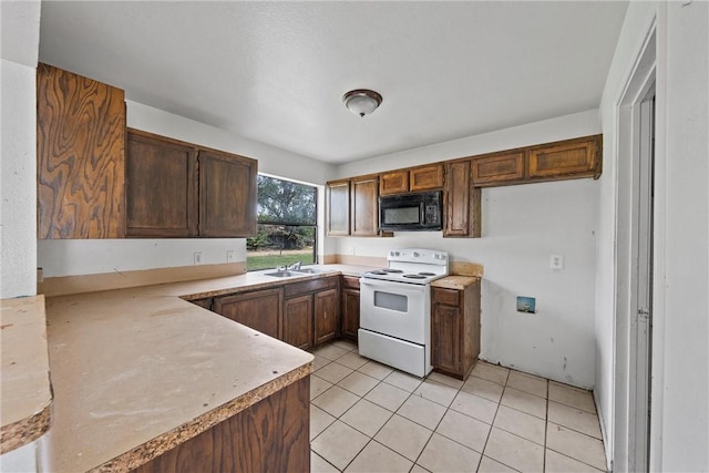 kitchen featuring white range with electric stovetop, light tile patterned floors, and sink