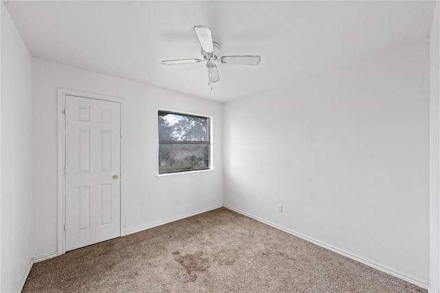 spare room featuring carpet flooring and ceiling fan