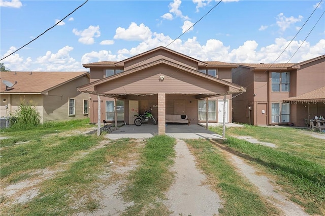 back of property with a carport